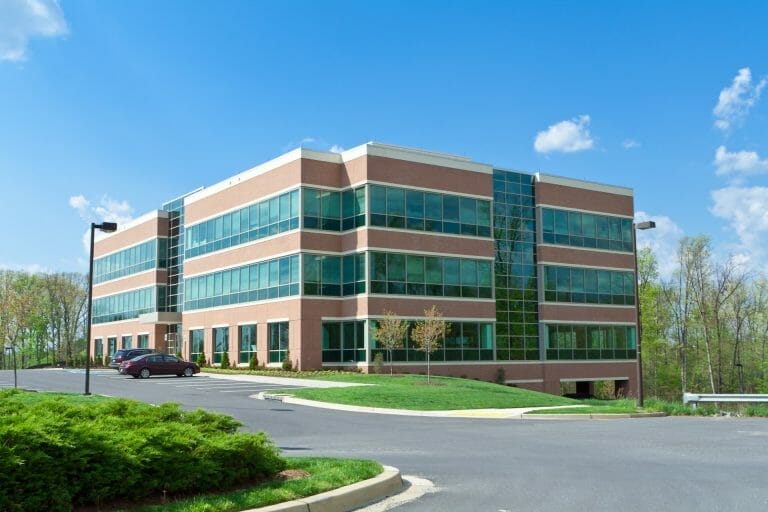 commercial office building, 3 floors with driveway and parking lot